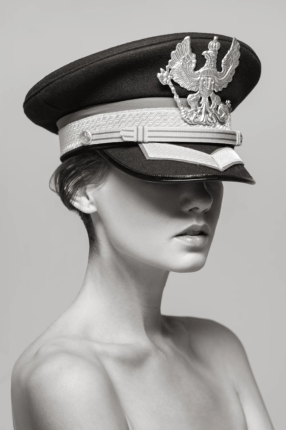 Black & white image of a woman wearing a military hat