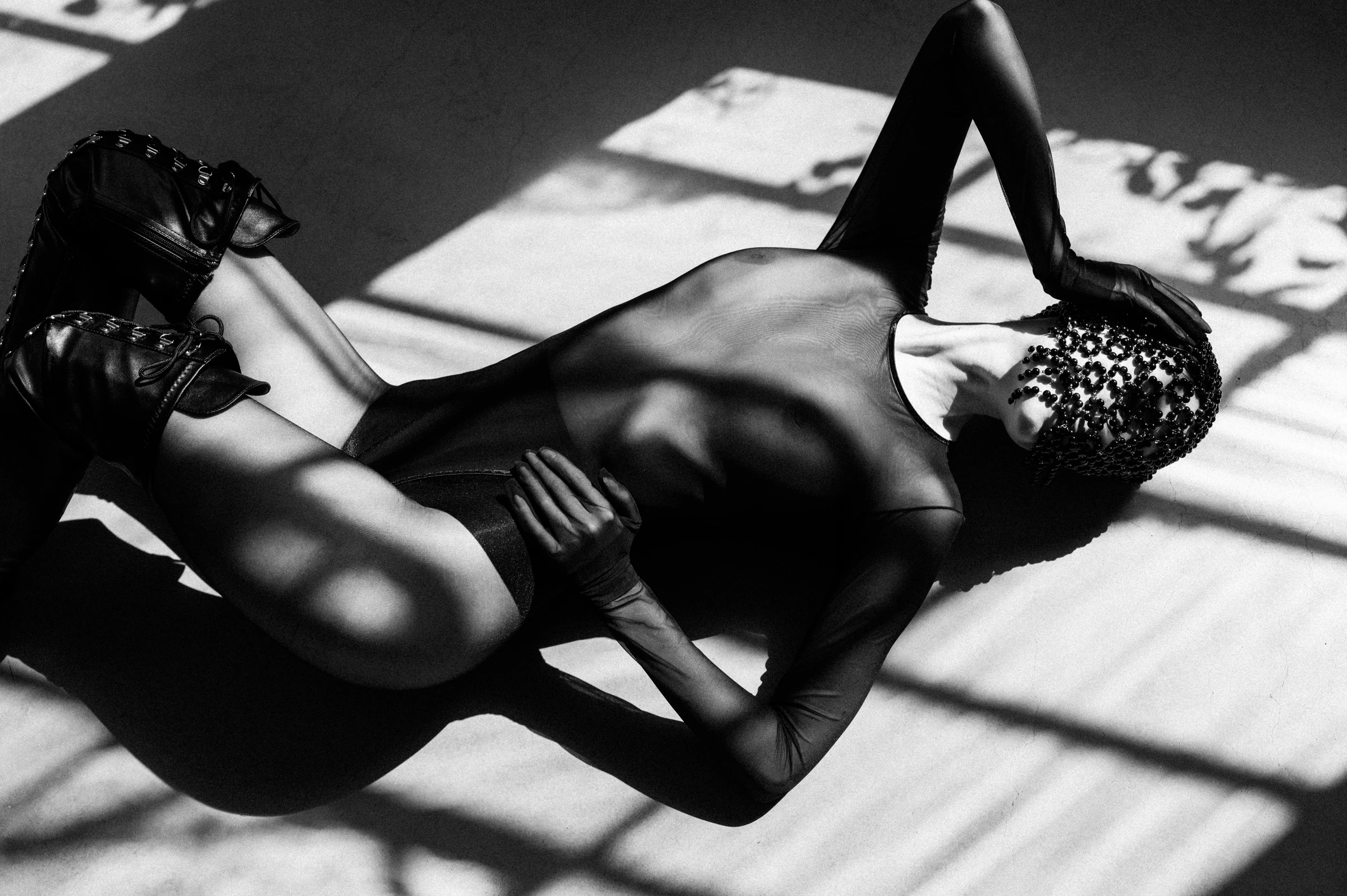 Model on the floor wearing a mask