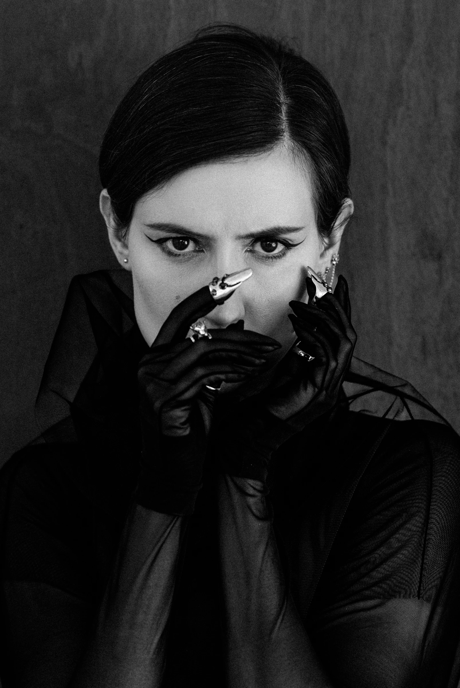 model wearing gloaves and nail jewerly